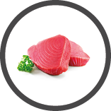 Fresh tuna fish fillet steaks garnished with parsley isolated on white background