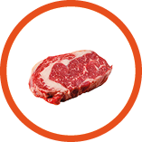 A rib eye steak of marbled grain-fed beef lies on a white background. Isolated.