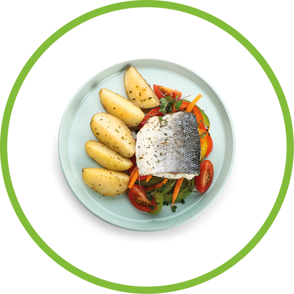 Plate of tasty sea bass fish with vegetables on white background