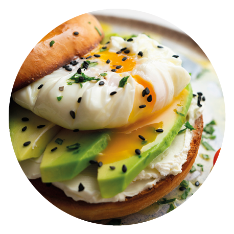 Toasted baggel with cream cheese, avocado, organic cherry tomatoes and poached egg. Vegan brunch.