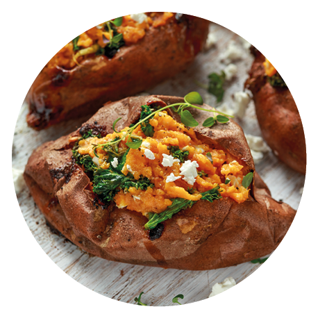 Roast sweet potato stuffed with feta cheese and kale. healthy food.