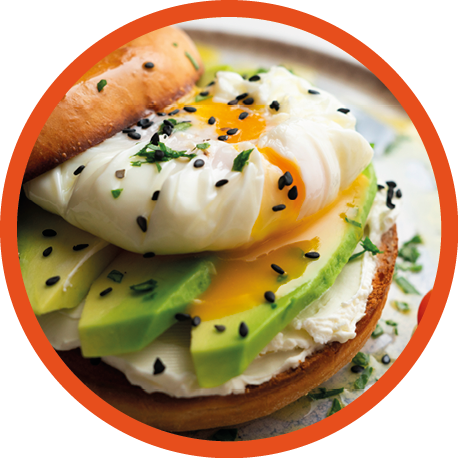 Toasted baggel with cream cheese, avocado, organic cherry tomatoes and poached egg. Vegan brunch.