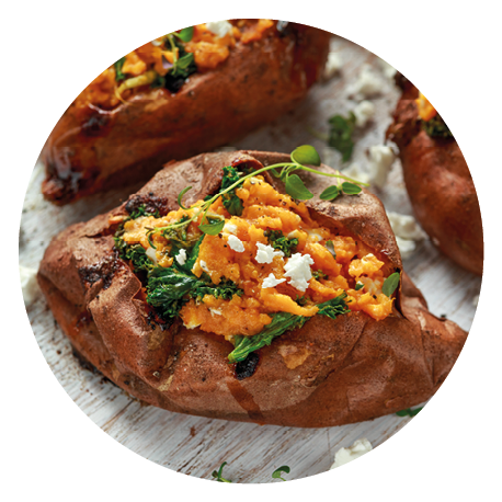 Roast sweet potato stuffed with feta cheese and kale. healthy food.