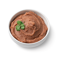 Bowl with Mexican brown refried beans paste close up isolated on white background