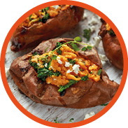 Roast sweet potato stuffed with feta cheese and kale. healthy food.