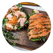 Sandwich toast with hot and cold smoked salmon, arugula and cream cheese on a wooden board. White background. Top view.