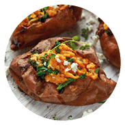Roast sweet potato stuffed with feta cheese and kale. healthy food.
