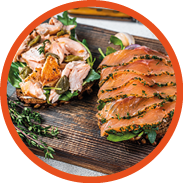 Sandwich toast with hot and cold smoked salmon, arugula and cream cheese on a wooden board. White background. Top view.