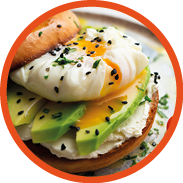 Toasted baggel with cream cheese, avocado, organic cherry tomatoes and poached egg. Vegan brunch.