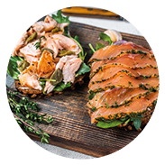 Sandwich toast with hot and cold smoked salmon, arugula and cream cheese on a wooden board. White background. Top view.