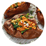 Roast sweet potato stuffed with feta cheese and kale. healthy food.