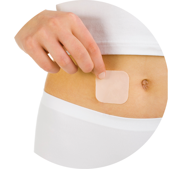 Woman's hand holding contraception patch sticked on abdomen. White background, front view