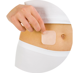 Woman's hand holding contraception patch sticked on abdomen. White background, front view