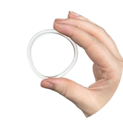 Birth control ring in a womans hand isolated on white background, vaginal ring for contraceptive use close-up