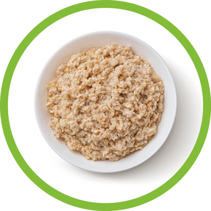 Bowl of oatmeal isolated on white background, healthy oat porridge breakfast, top view