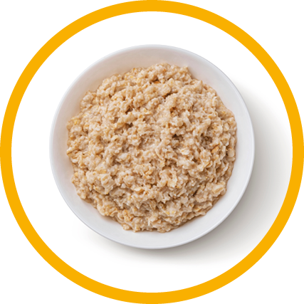 Bowl of oatmeal isolated on white background, healthy oat porridge breakfast, top view