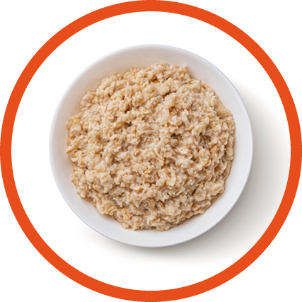 Bowl of oatmeal isolated on white background, healthy oat porridge breakfast, top view