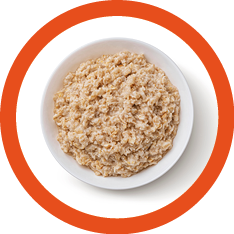 Bowl of oatmeal isolated on white background, healthy oat porridge breakfast, top view