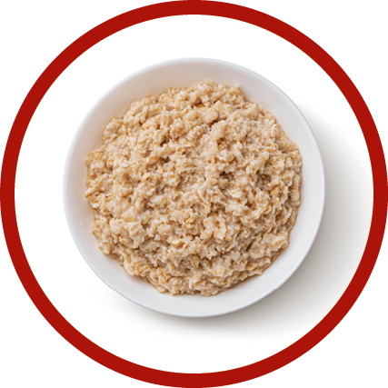 Bowl of oatmeal isolated on white background, healthy oat porridge breakfast, top view