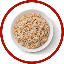 Bowl of oatmeal isolated on white background, healthy oat porridge breakfast, top view