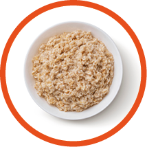 Bowl of oatmeal isolated on white background, healthy oat porridge breakfast, top view