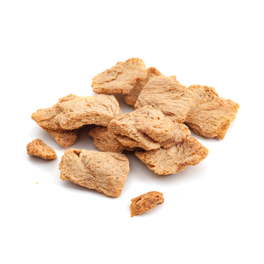 Vegetarian protein source vegan alternative to meats and biotechnology concept with group of raw dehydrated soy meat or soya textured chunks isolated on white background