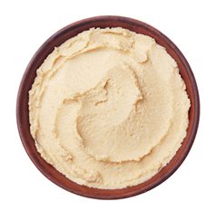 Flat lay view at hummus - spread made from cooked, mashed chickpeas blended with tahini, lemon juice, and garlic isolated on white background. Clipping path added