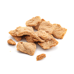 Vegetarian protein source vegan alternative to meats and biotechnology concept with group of raw dehydrated soy meat or soya textured chunks isolated on white background